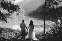 black and white wedding portrait with lake